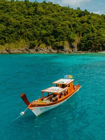 Take a private long tail boat to idyllic Racha Yai Island.