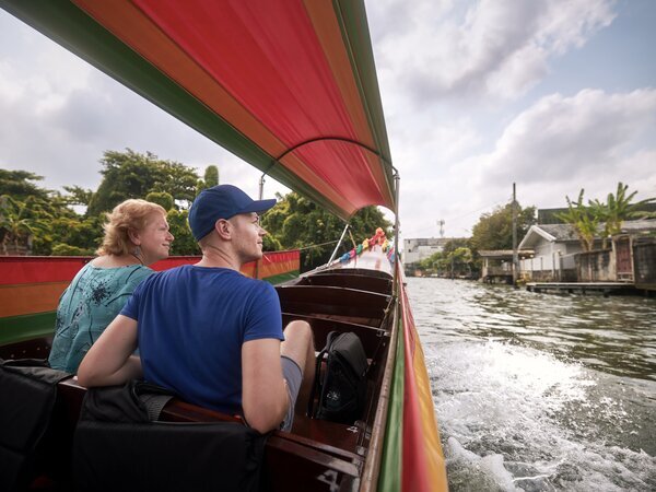 Cruise along Bangkok's ancient canals and visit a floating market.