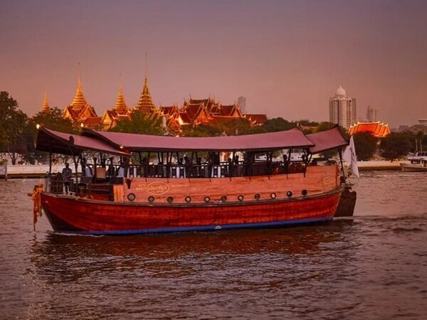 Enjoy a Thai dinner cruise aboard a luxurious Manohra river boat.