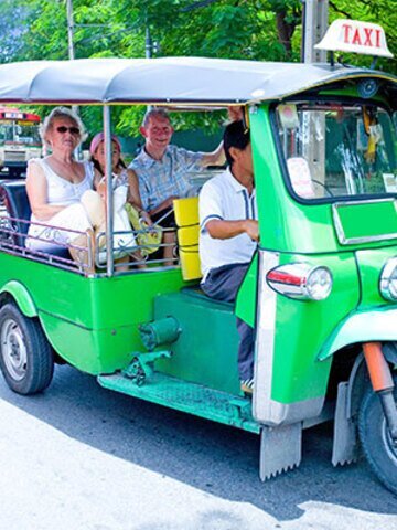 Explore Bangkok's charm with characteristic local transport.