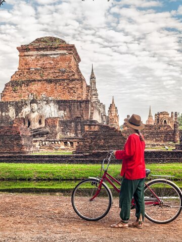 Cycle through the ruins of first independent Thai kingdom at Sukhothai Historical Park.