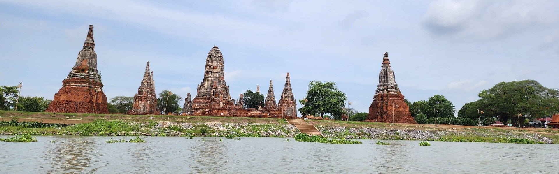 Cruising past riverside temples on a longtail boat ride.