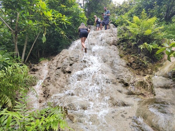 Climb up the unique surface of Bau Thong Sticky Waterfall.