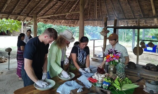 Learning to cook Thai food with locals.