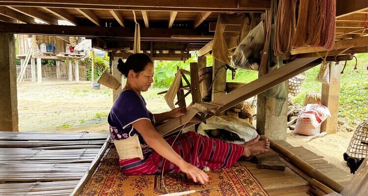 A Karen woman weaves at Maeklang Luang Karen Village.