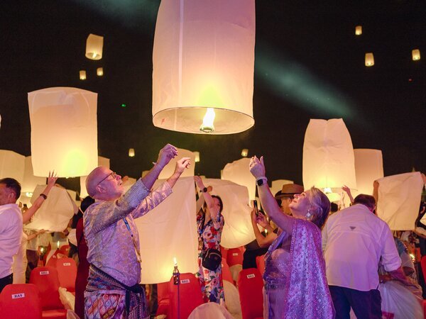 Wearing Thai cotumes to attend the festival.