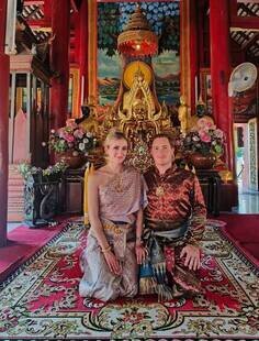 Visiting a Thai temple dressed in traditional Thai attire.