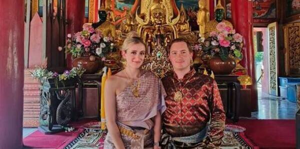 Visiting a Thai temple dressed in traditional Thai attire.