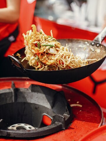 Dive into a vibrant night market filled with the sizzling scents of street food.