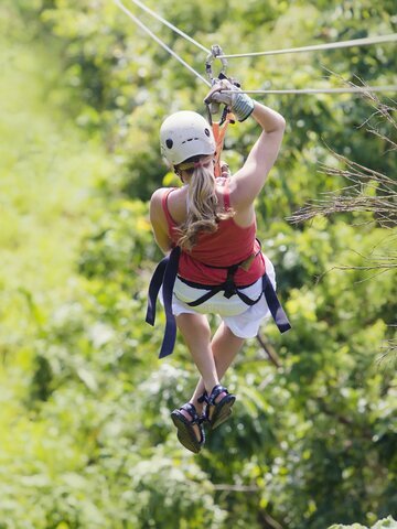 Soar through the rainforest canopy for 800 meters on Thailand's fastest roller zipline.