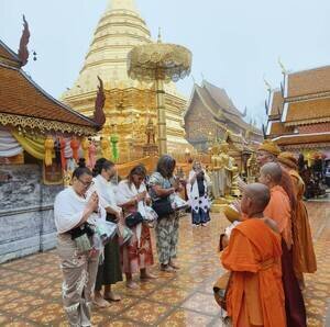 Taking part in a traditional alms-giving ceremony.