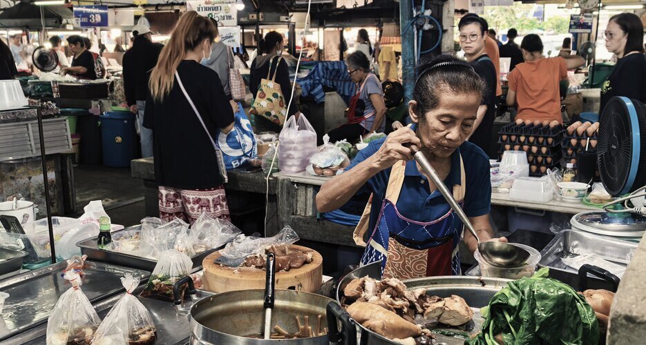 Elderly woman preparing food at Chiang Mai Gate Market