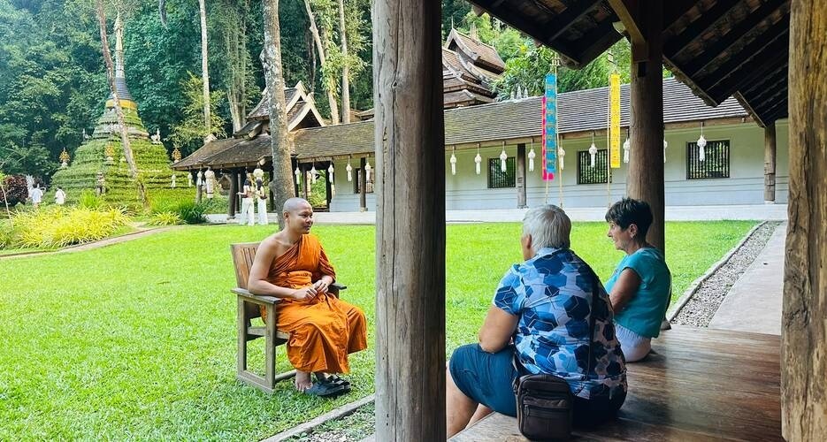 Our Canadian guests, Suansan and Bonny, chatting with a monk in the peaceful courtyard of Wat Pha Lat.
